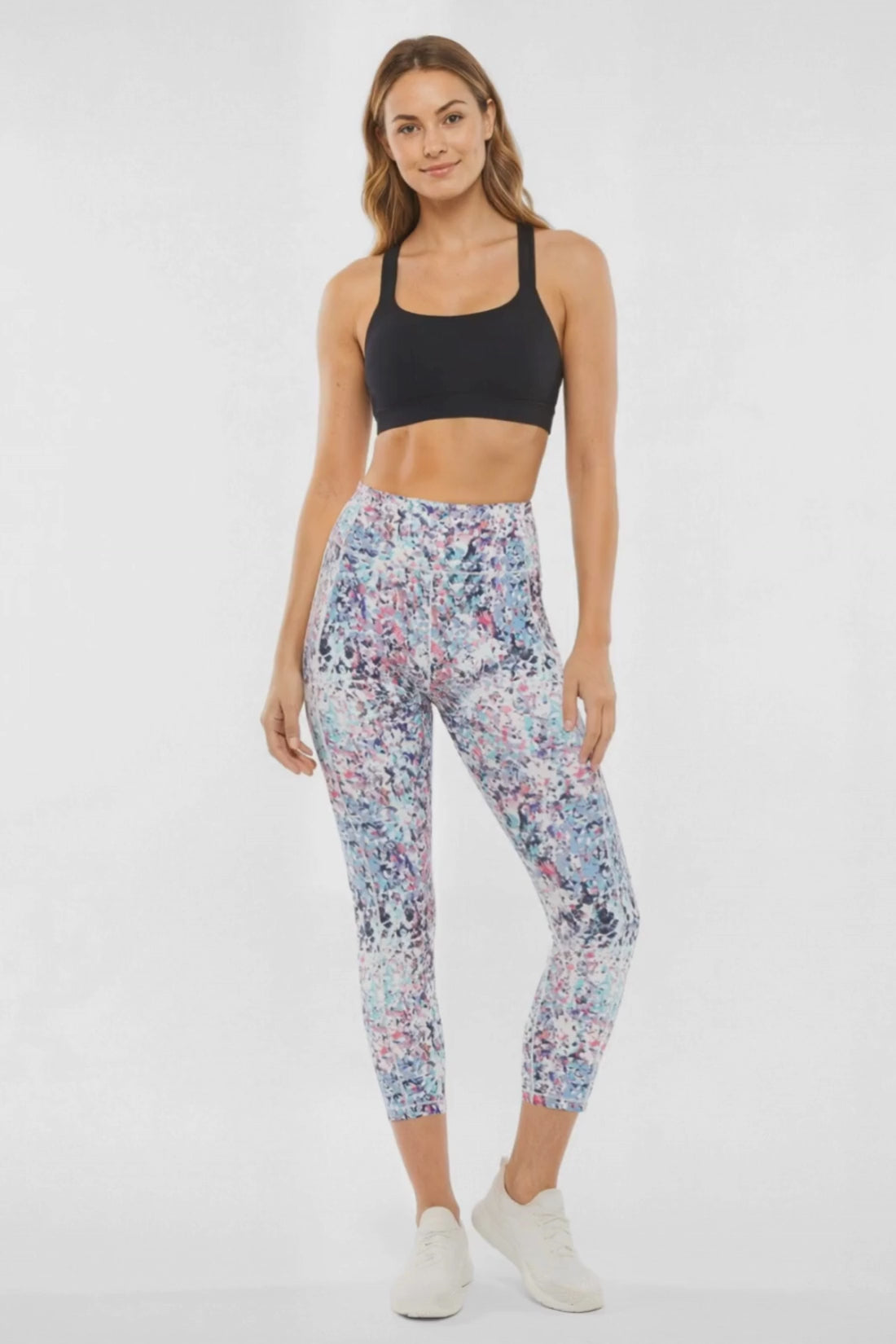Video view of woman wearing colorful floral leggings on a white background. #color_pink-flambe-digital-pieces
