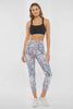 Video view of woman wearing colorful floral leggings on a white background. #color_pink-flambe-digital-pieces