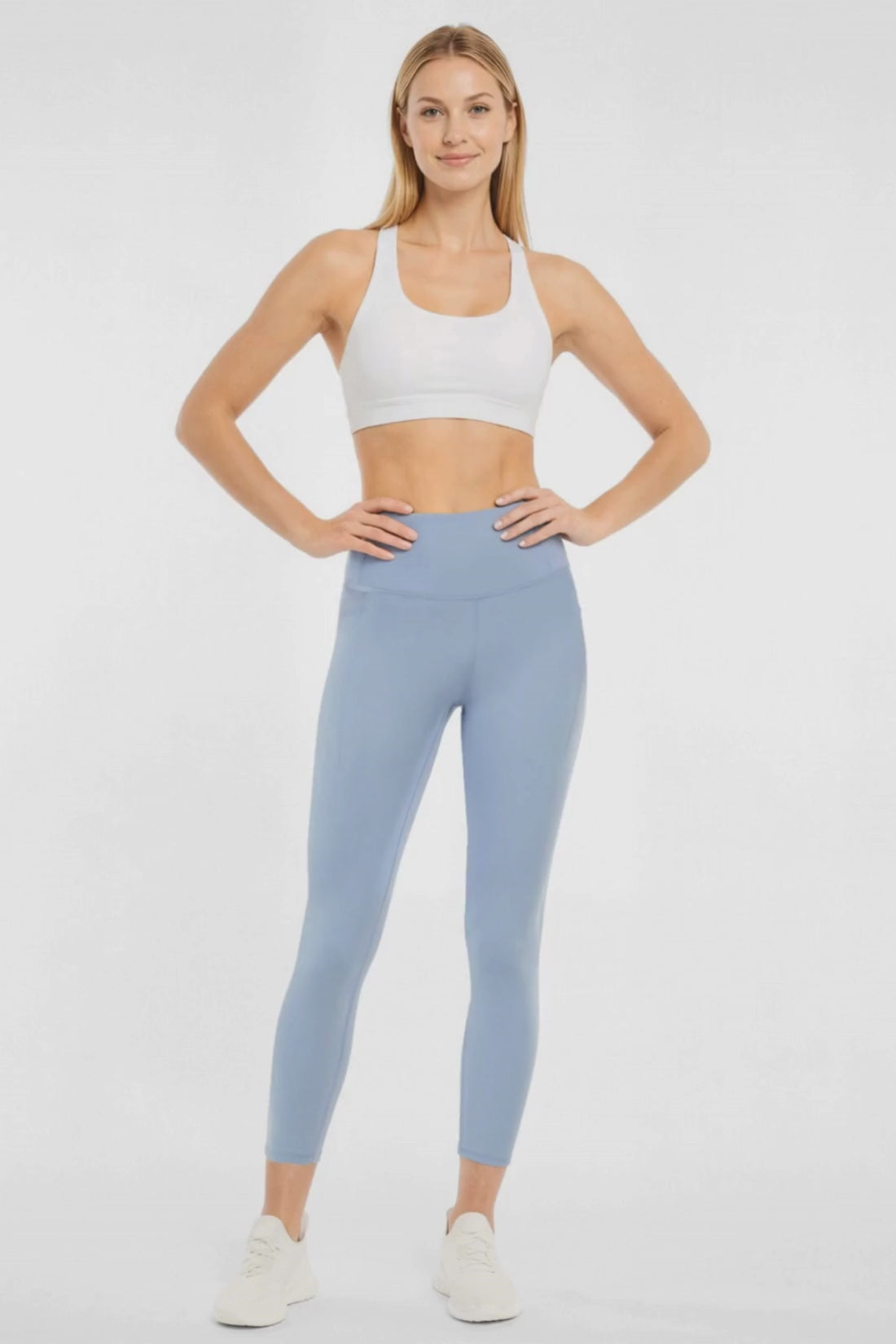 Video view of woman wearing light blue leggings worn by a person on a white background. #color_troposphere