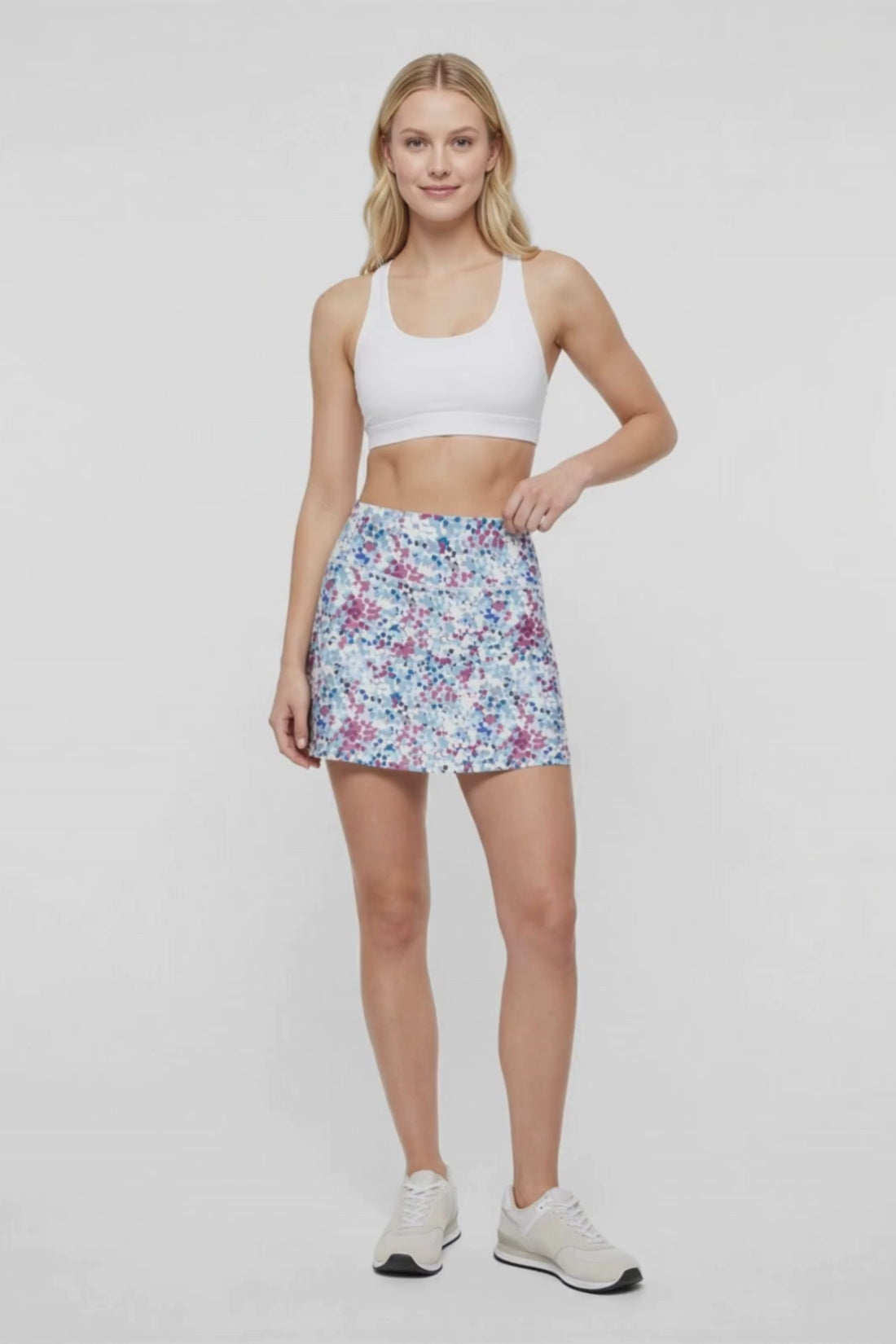 Video view of woman wearing spotted floral patterned skort design on a white background. 