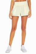 Mila Short, alternate angle view, showing visible design features and texture of the soft knit fabric.. #color_heather-wax-yellow